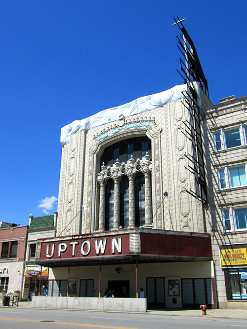 After a series of unsuccessful efforts at renovation, the Uptown Theatre (1925) now sits neglected with its doors boarded up and its facade covered up by a tarp.
