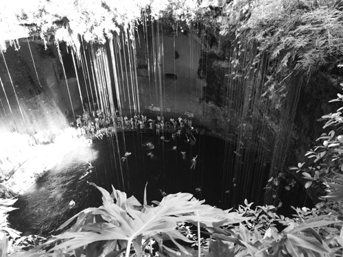 Tourists swimming in Cenote Ik Kil