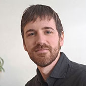 Man with short hair and grey shirt