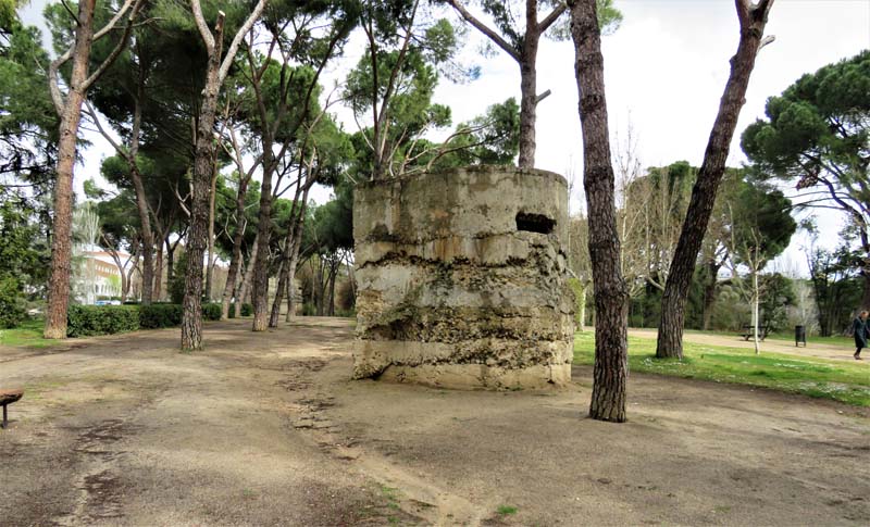 corroding bunker, sandy parkland with trees