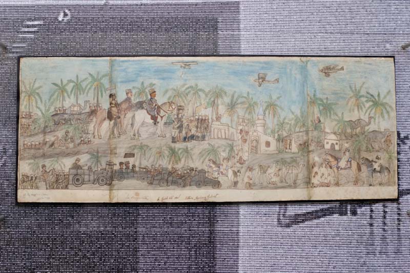 An overhead view of a drawing of people riding horses with palm trees and buildings along the street