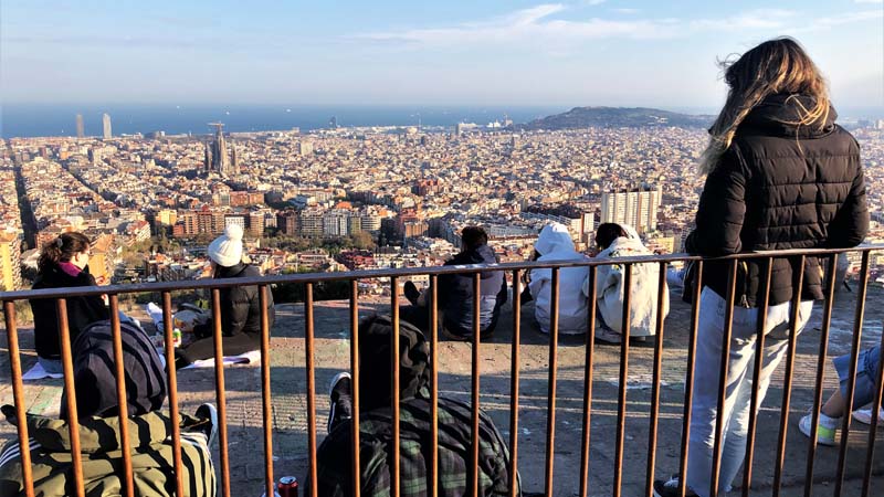 people sitting on top of building overlooking the city