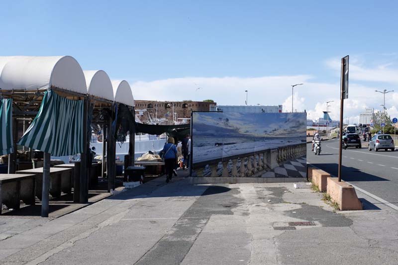 A  large photograph next to a street