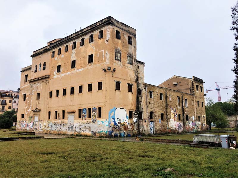 multi-story building with deteriorating walls with graffiti