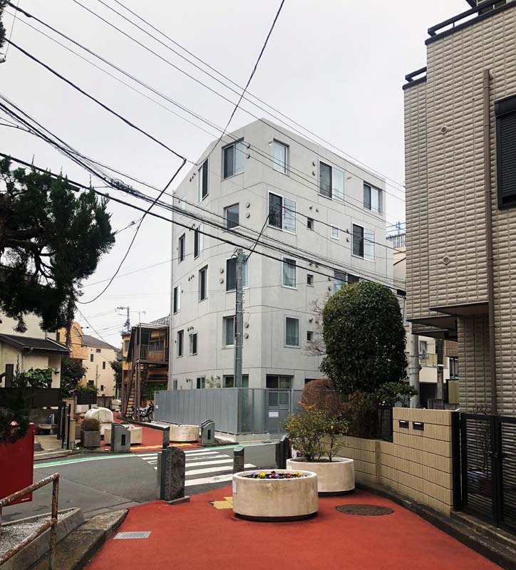 pedestrian walkway weaves through buildings