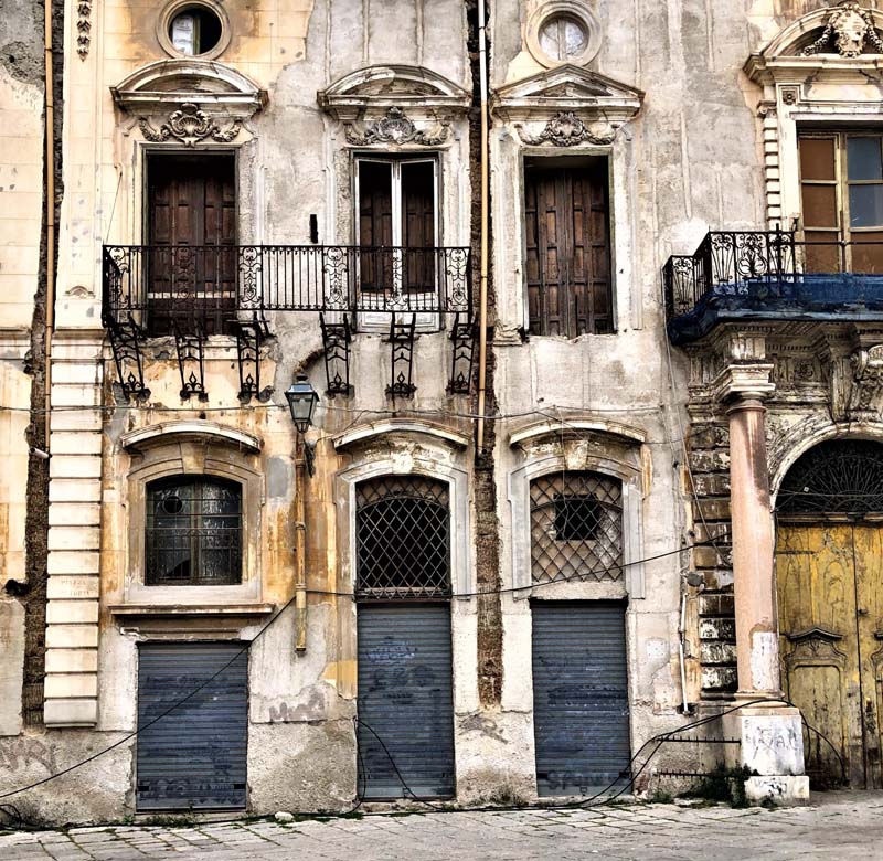 deteriorating facade with Juliette balconies