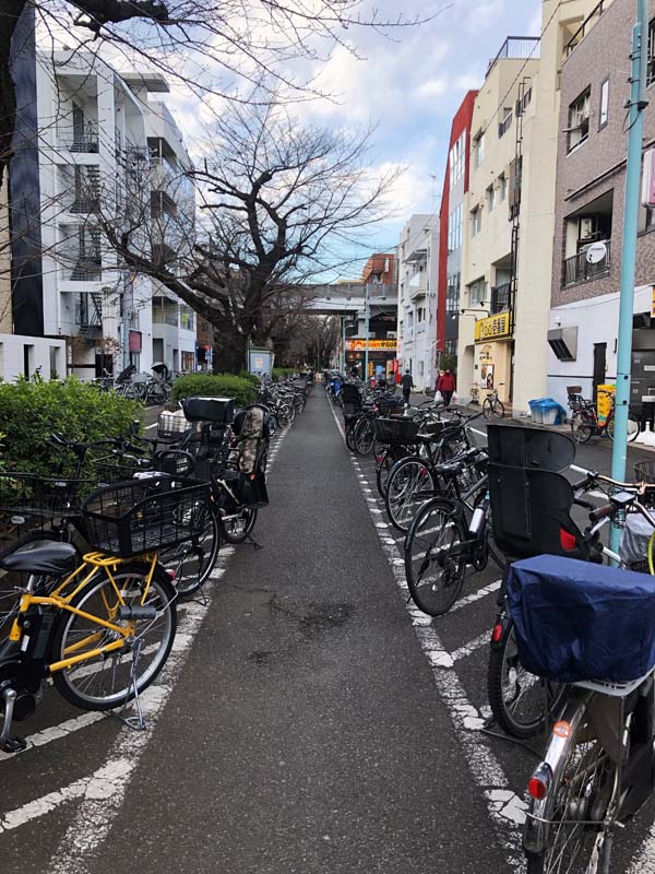 bicycles parked along path between buildings