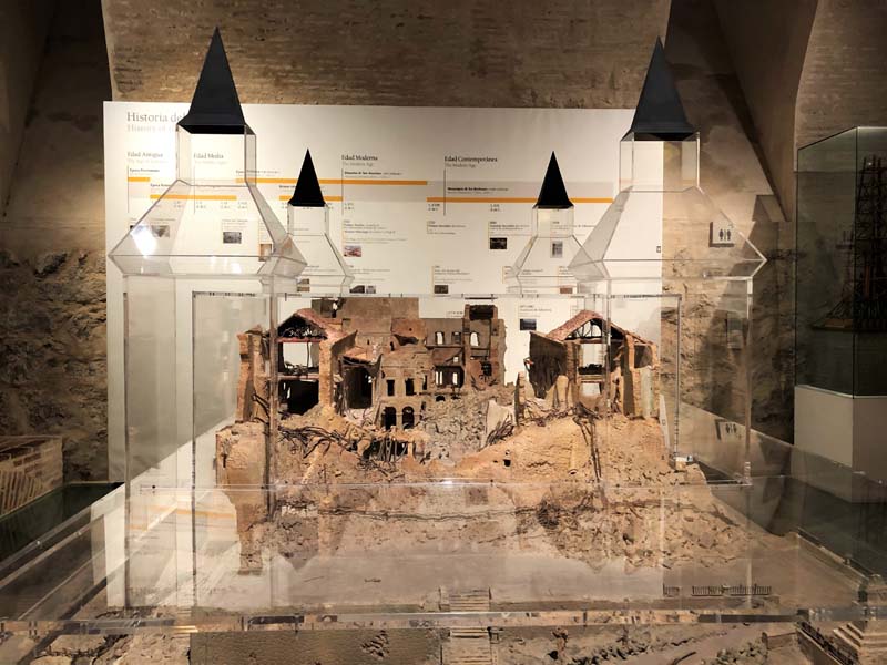 model showing ruins with wall text in background