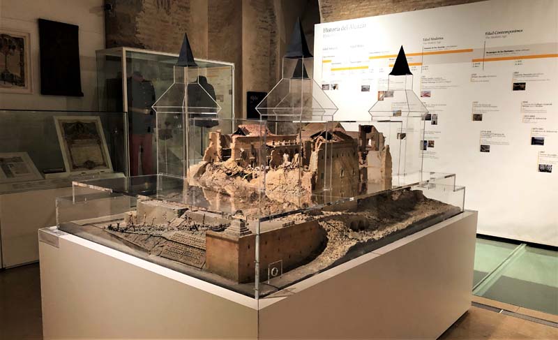 glass model, wall text in and museum cases in background