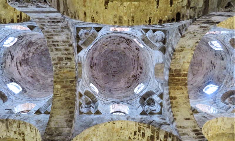 view looking up at brickwork of three domes