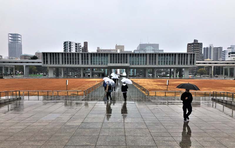 people walk through plaza