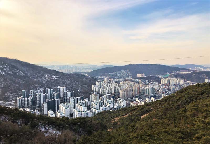 aerial view of city surrounded by mountains