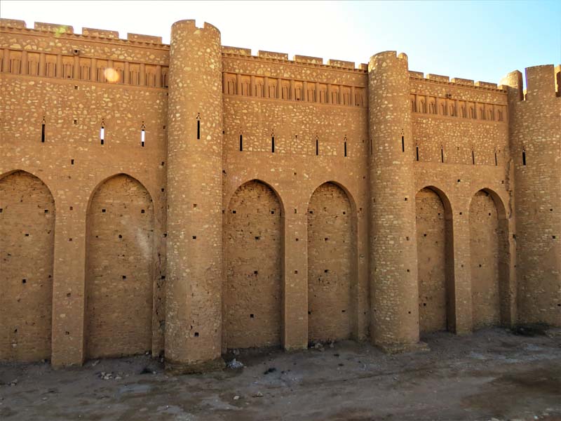 stone walls of fortress with arches and turrets