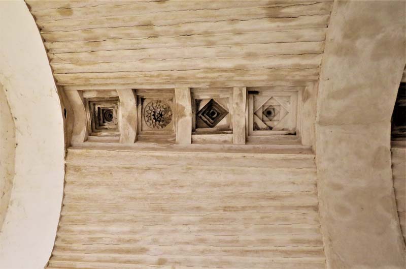 four geometric designs inset in squares in barrel vault