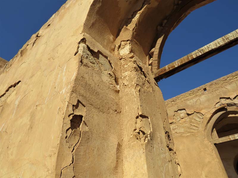 detail of deteriorating stone arched entryway