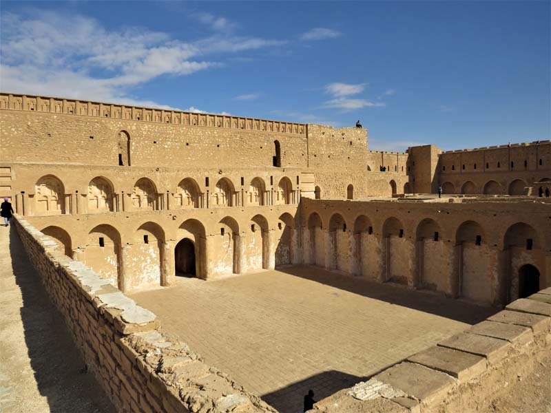 view from inside fortress with paved atrium surrounded by arcade