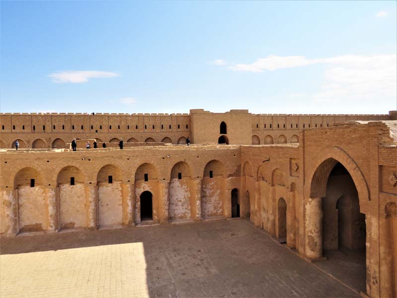 view into atrium within fortress, people in background