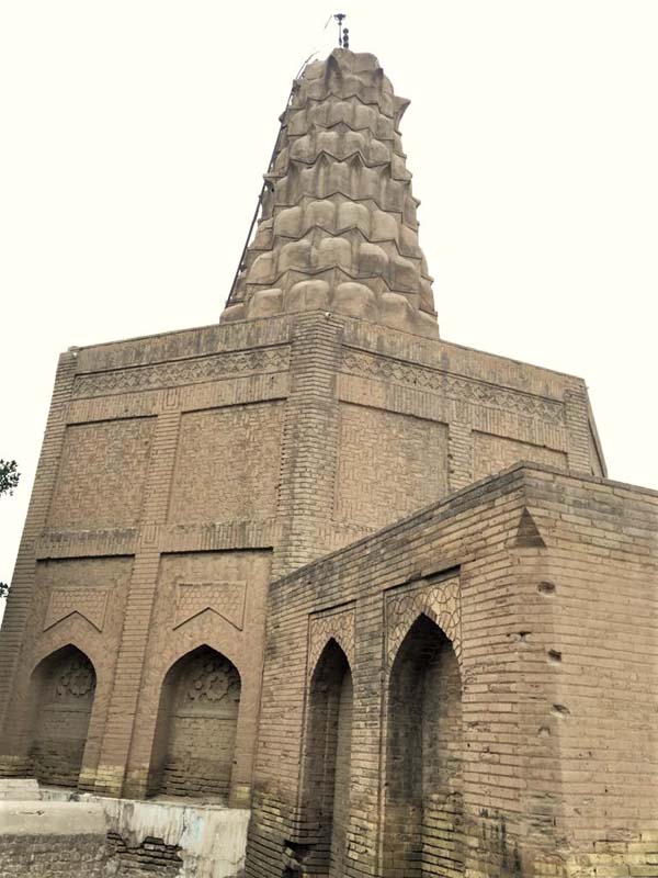 brick mausoleum with octagonal base and muqarnas dome