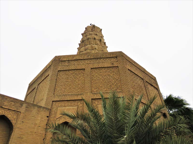 octagonal mausoleum with ornate brickwork and muqarnas dome
