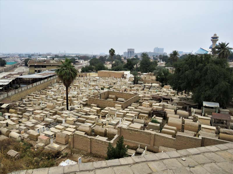 view over cemetery with cityscape in background