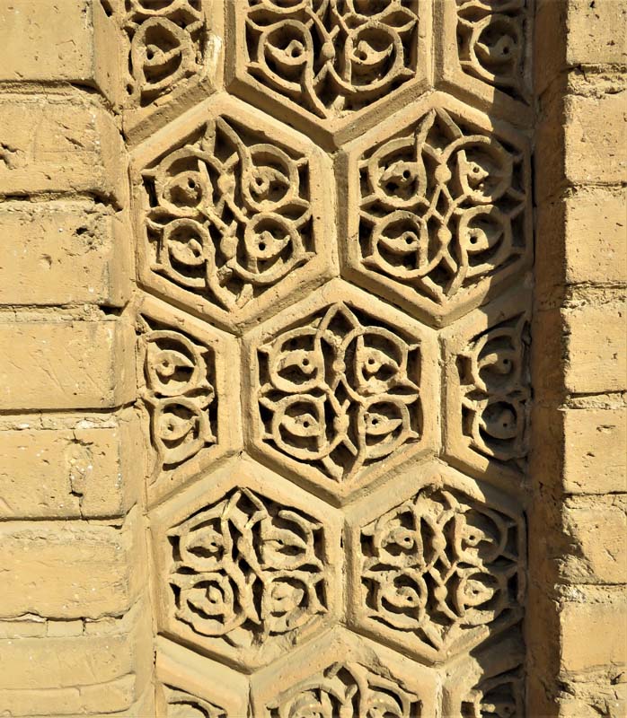 ornamental stonework with floral shapes inside hexagon pattern