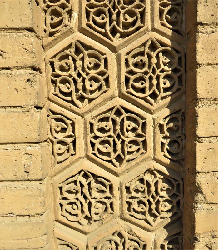 ornamental stonework with floral shapes inside hexagon pattern