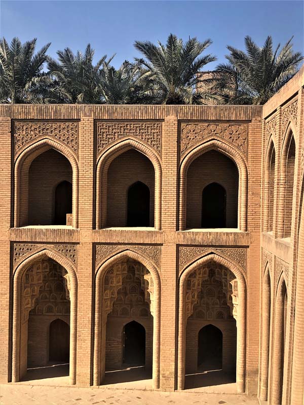 double arcade with palm trees in background