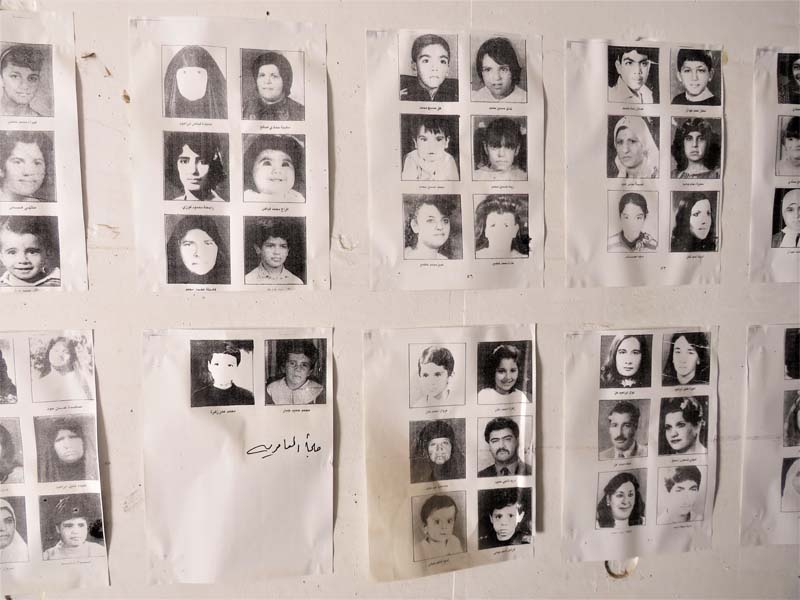 black and white photocopies of photos of victims attached to a white wall