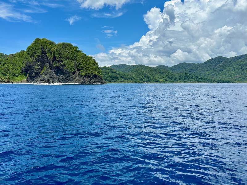 sea with green hills in background