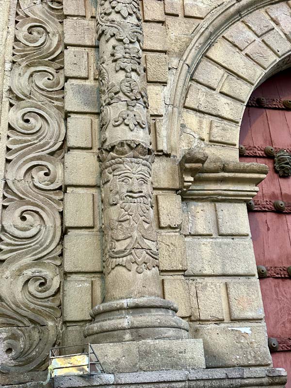 figures carved in stone column