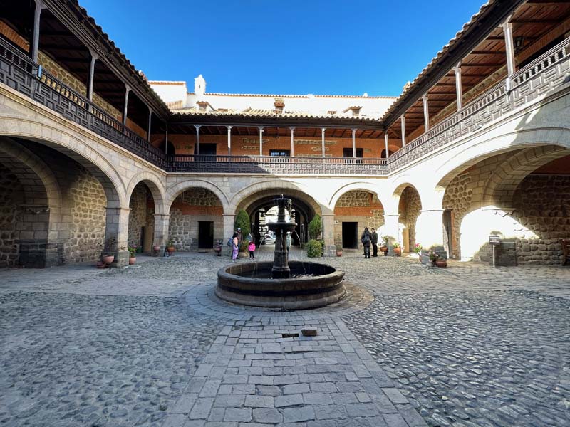 large courtyard with round fountain in center