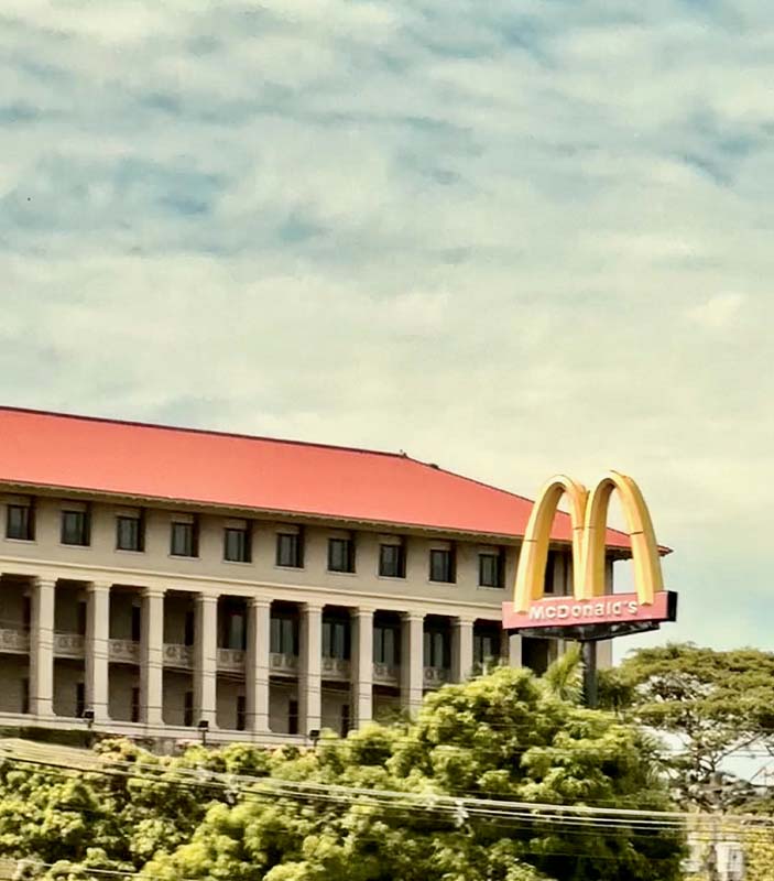 McDonald's sign with building in background