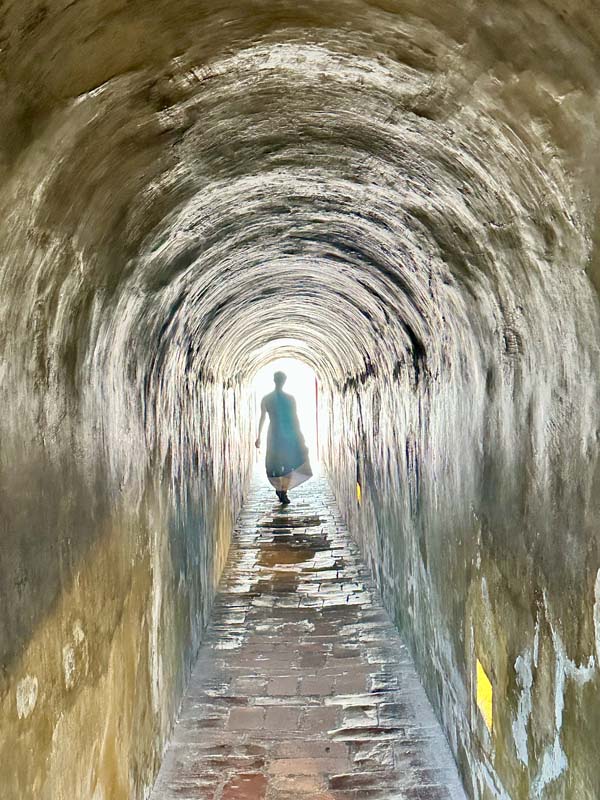 silhouette of person in a narrow tunnel