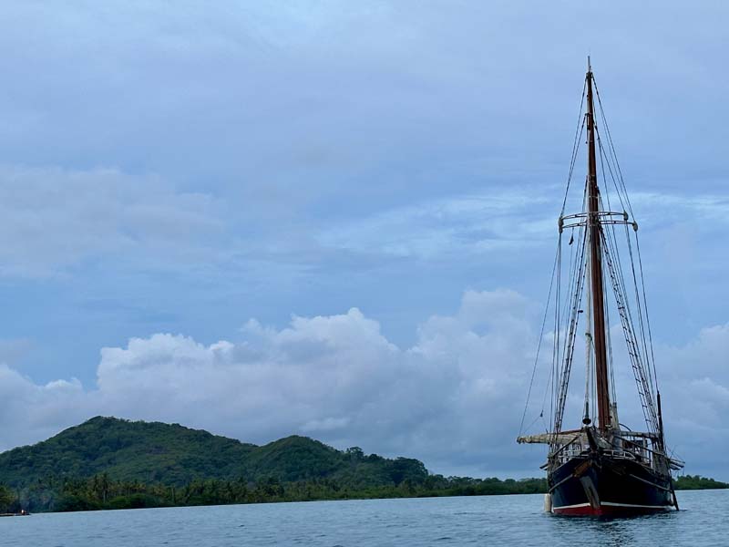 sailboat in water with land in background