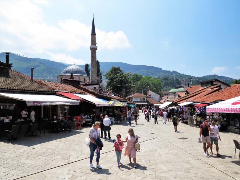 people walking with shops on either side