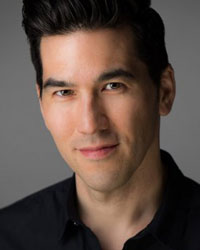 Jason Nguyen, a man with short black hair, wears a black collared shirt against a gray background