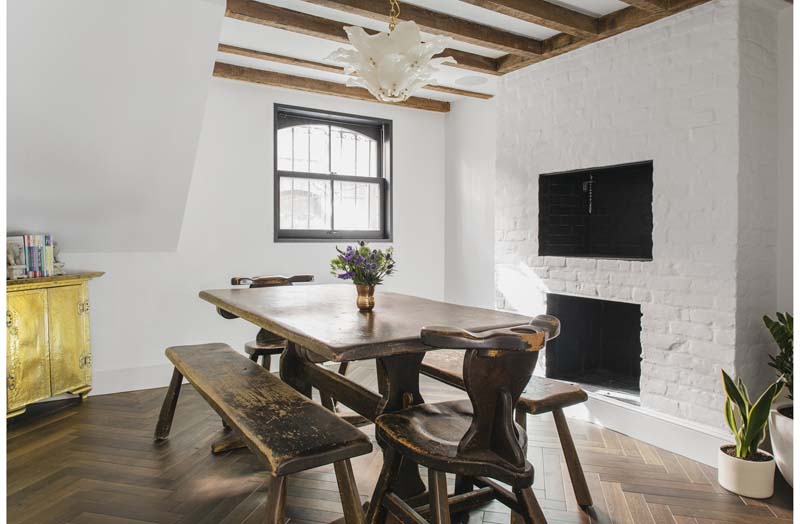 white interior with wooden dining table and chairs