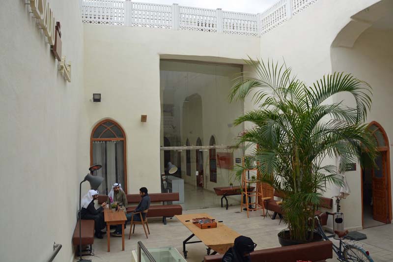 High white walls topped with a decorative balustrade enclose an interior courtyard open to above