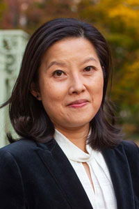 Alice Tseng, an Asian woman with shoulder-length hair, wears a white blouse and black jacket