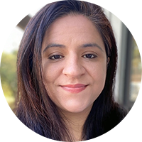 Indian woman with long brown hair and black shirt