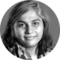  Jigna Desai, and Indian woman with brown hair, wears a dotted scarf