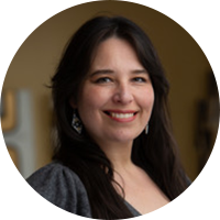 Woman with long black hair and grey shirt