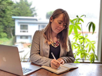 Ashley Gardini takes notes with laptop