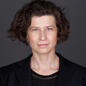 Woman with short brown hair and black blazer