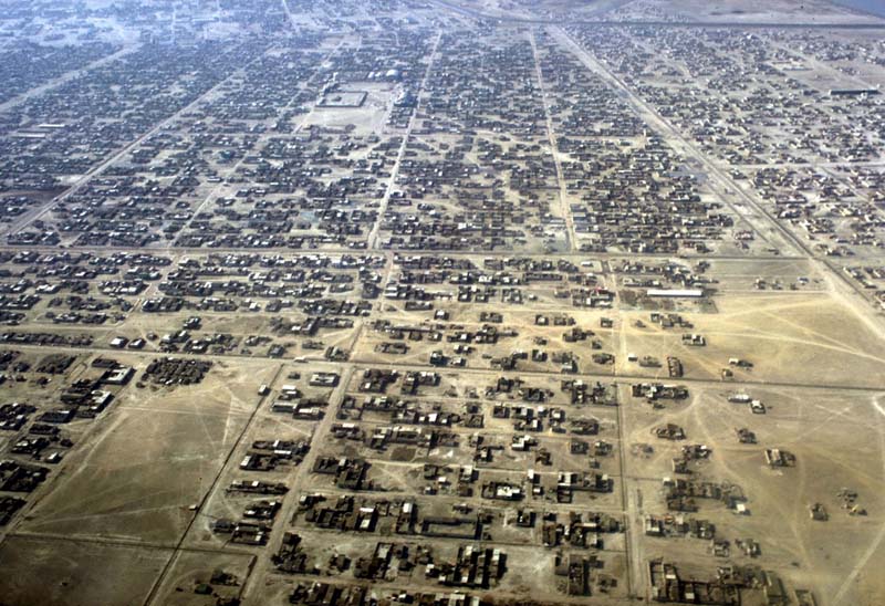 An aerial image of a flat landscape with short buildings and streets