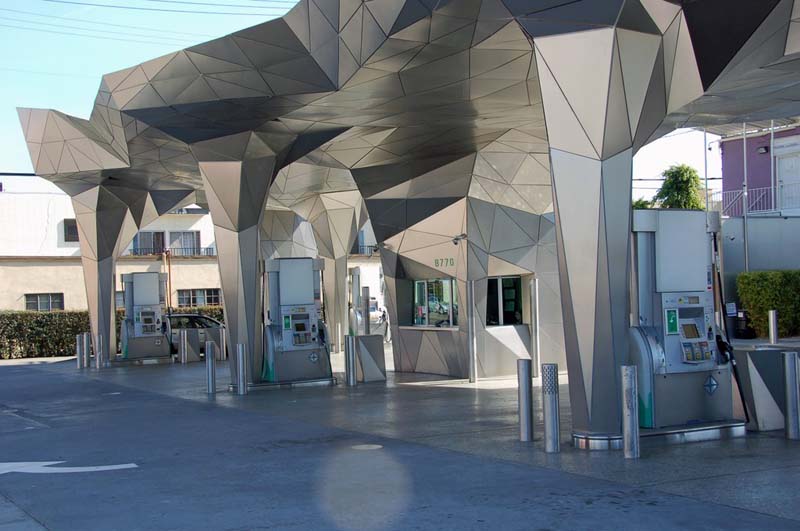 gas station with vaulted canopy of steel triangles