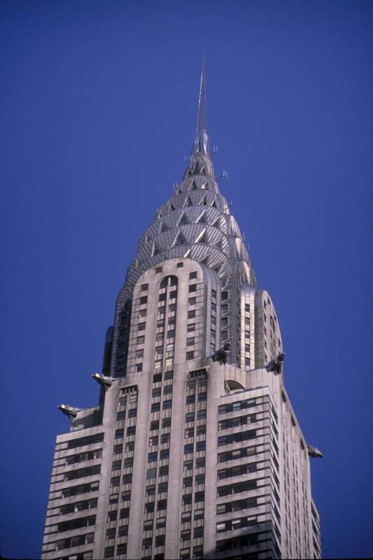 the top of the Chrysler Building against a blue sky