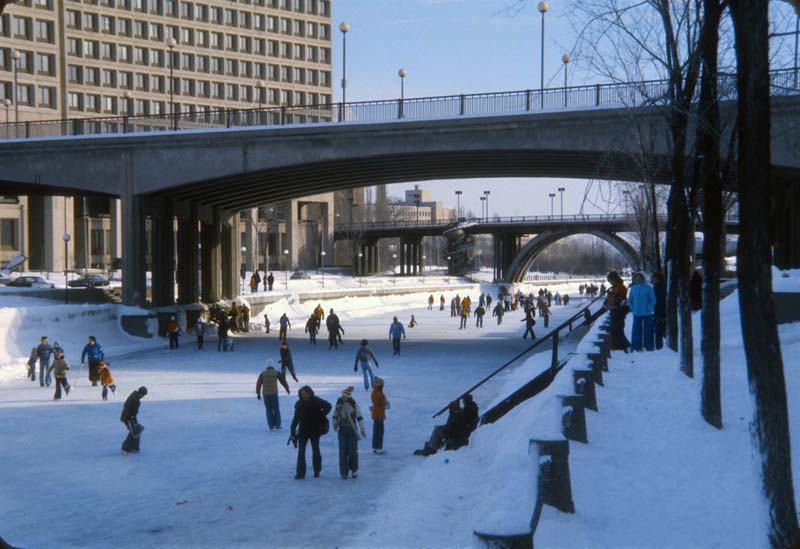 ice skater on river beneath bridges
