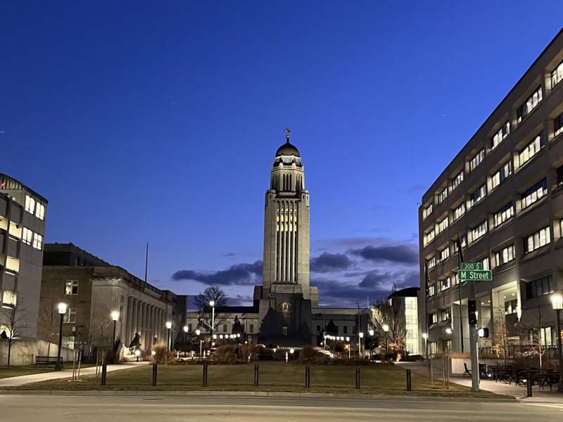 civic building and plaza lit up at night