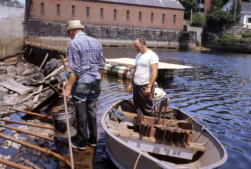two men making repairs in canal